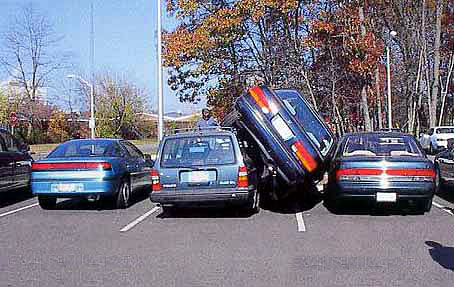 Car Squeezed In Parking Lot